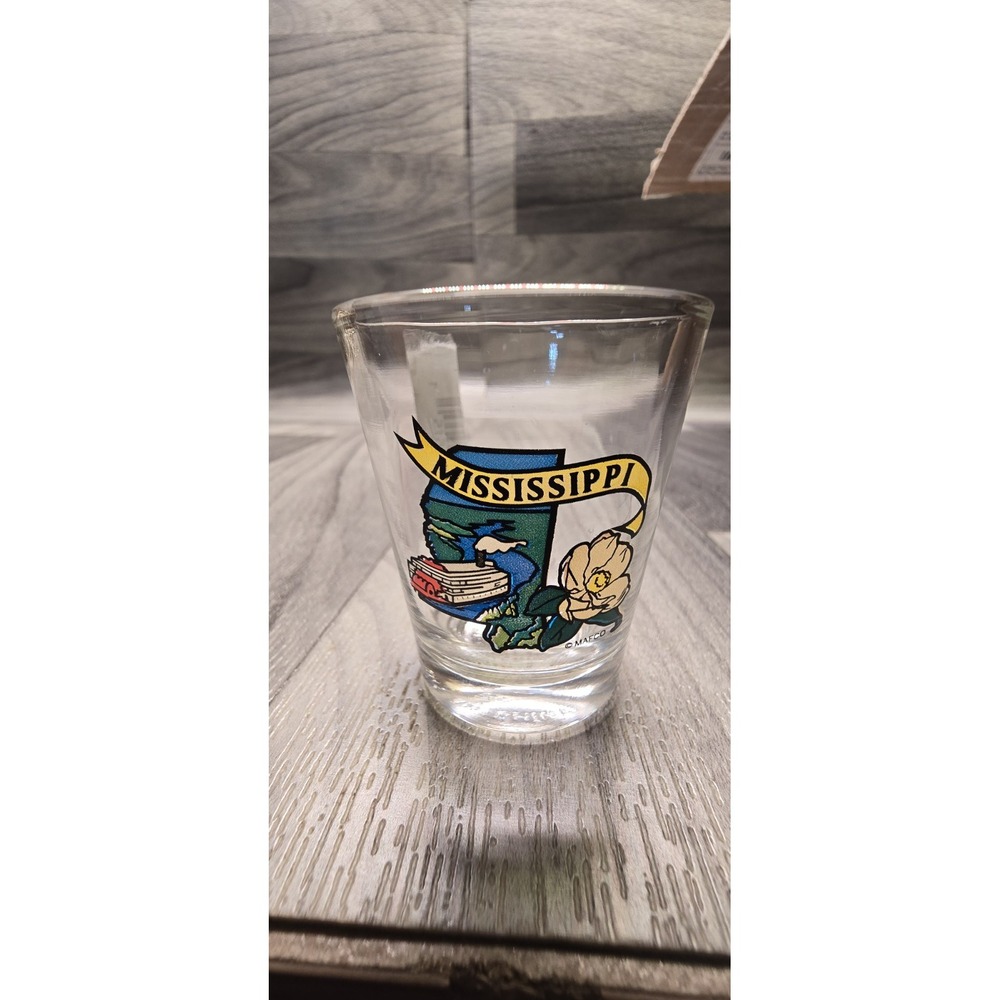 clear glass souvenir shot glass featuring a colorful Mississippi state map